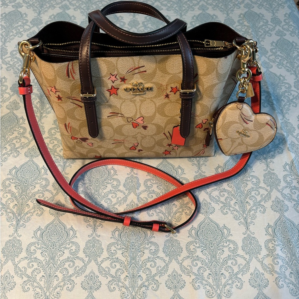 Coach heart punch bag charm in signature canvas with hearth and start print.
